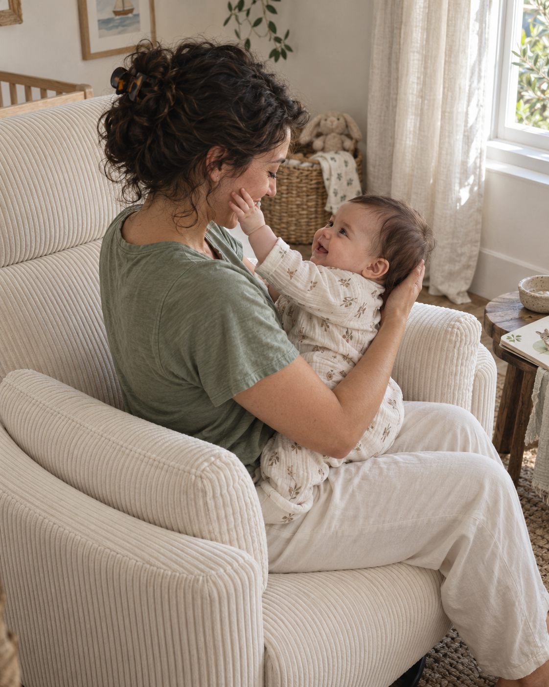 Styled lifestyle scene of a mother and her awake baby sharing a close moment in The Cove chair