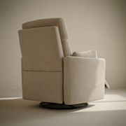 Rear three-quarter view of The Cove nursery recliner, showing the upholstered back and circular base